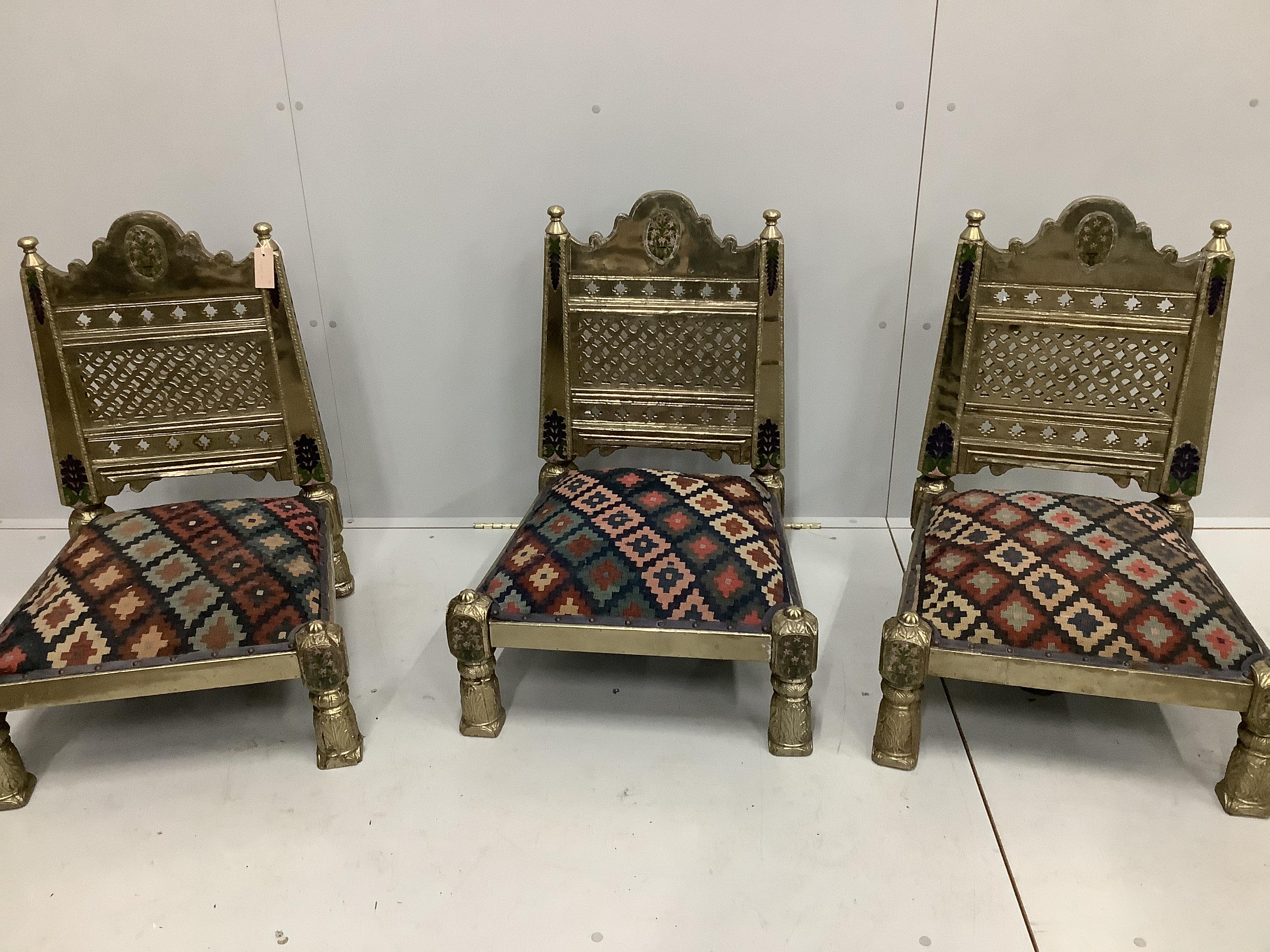 Three Indian metal clad Pidha low chairs with enamelled decoration and Kilim covered seats, width 58cm, depth 55cm, height 75cm